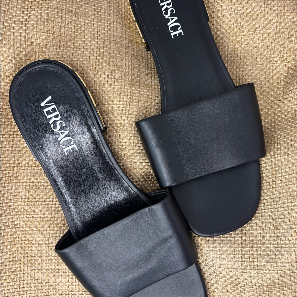 Versace Elegant Black Slide Sandals with the iconic logo in gold on the heel